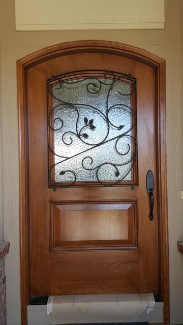 Entry door with custom iron scrollwork insert