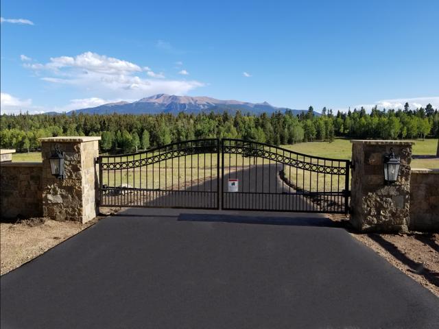 Estate swing gate with stone pillars in the Black Hills