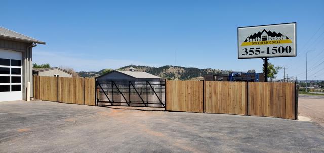 Security slide gate and cedar fence at South Dakota Overhead Doors