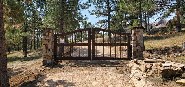 Arched gate with stone pillars in the pines