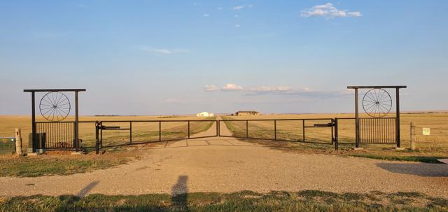 Wagon wheel ranch entrance on open prairie