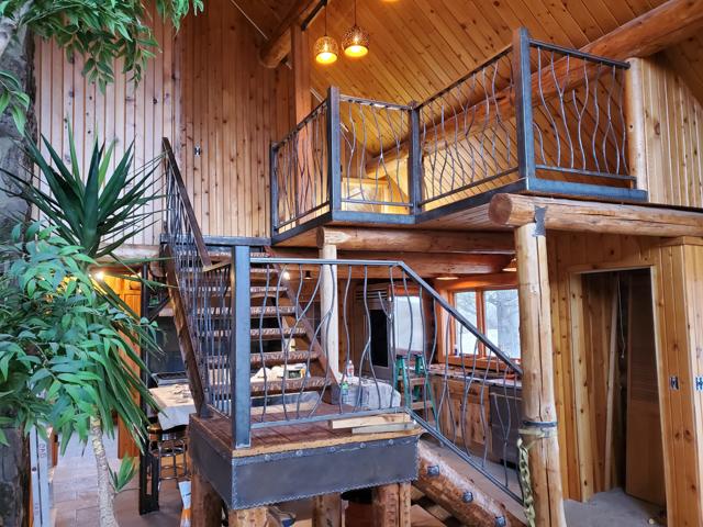 Hand-formed steel railings in a log home