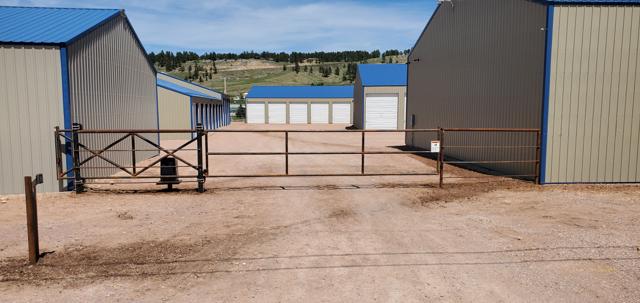 Automated pipe slide gate at a storage facility