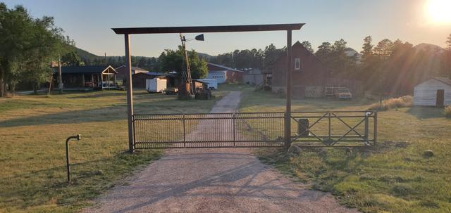Ranch entrance with overhead beam at sunset