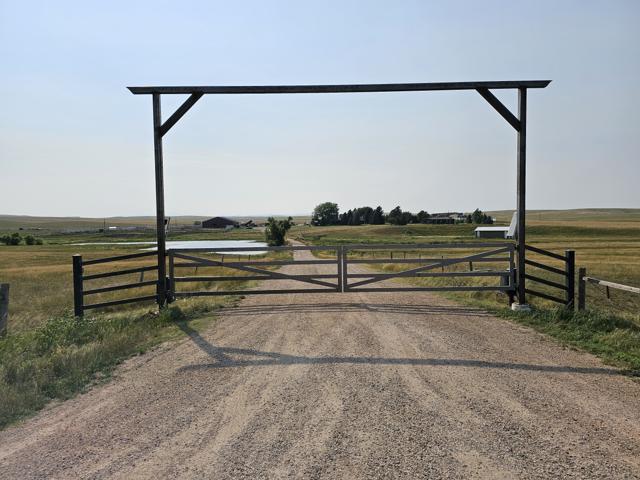 Timber ranch entrance archway with steel gate