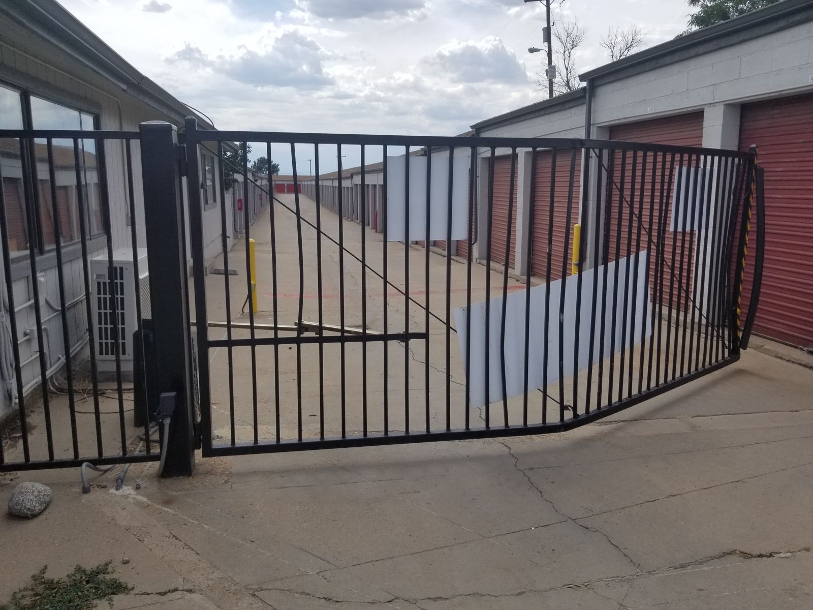 Slide gate bent by a vehicle strike at a storage facility
