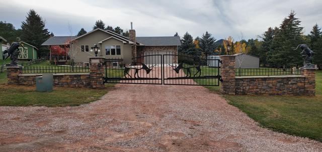 Ornamental gate with fighting elk silhouettes