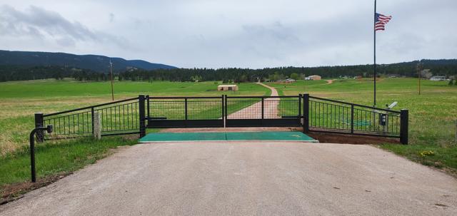Slide gate with matching rail fencing and cattle guard