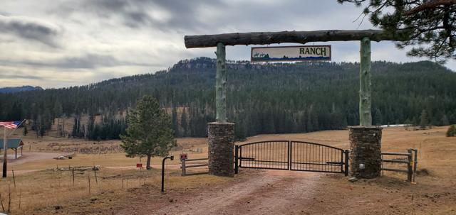 Ranch entrance with timber archway and arched gate