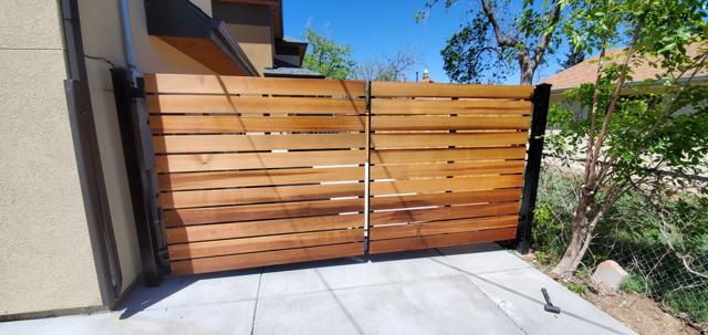 Modern horizontal cedar and steel driveway gate